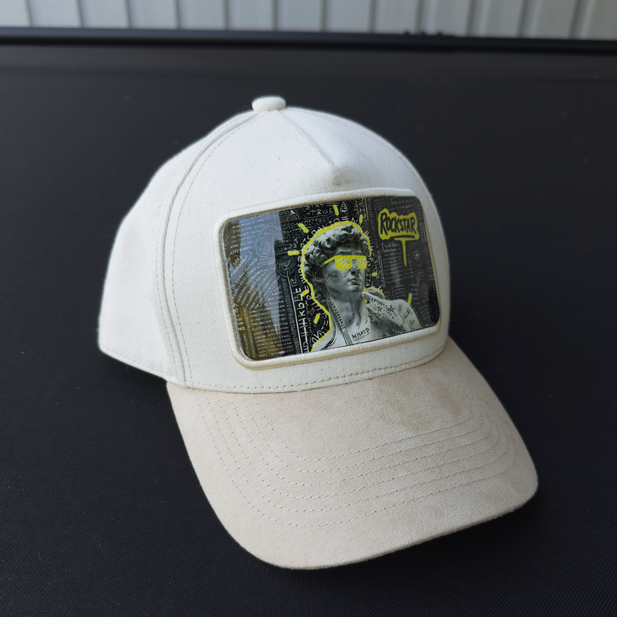 Rockstar David Art Plate on a Bjork Art Cap, photographed on a car dashboard